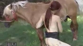 Redheaded zoophile riding a dildo and fucking a horse