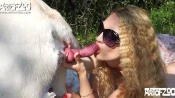 Blond-haired babe gets drilled by a dog in an outdoor vid